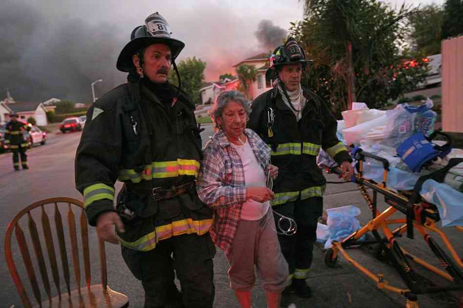 A woman is treated by firemen after the explosion. Hospitals reported receiving about 20 injured patients — several of whom were in critical condition. 