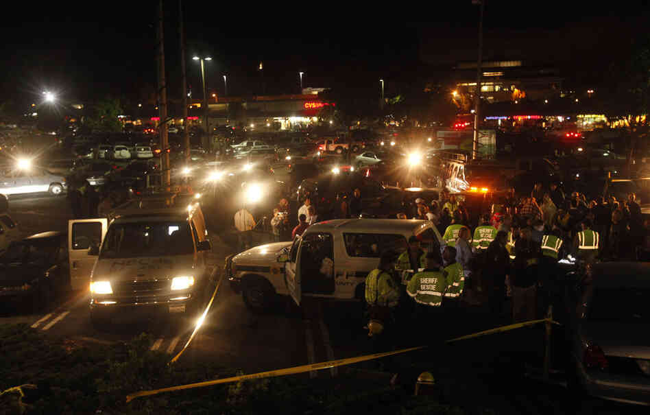 Police and fire officials meet at an area where evacuees gathered after the explosion. 