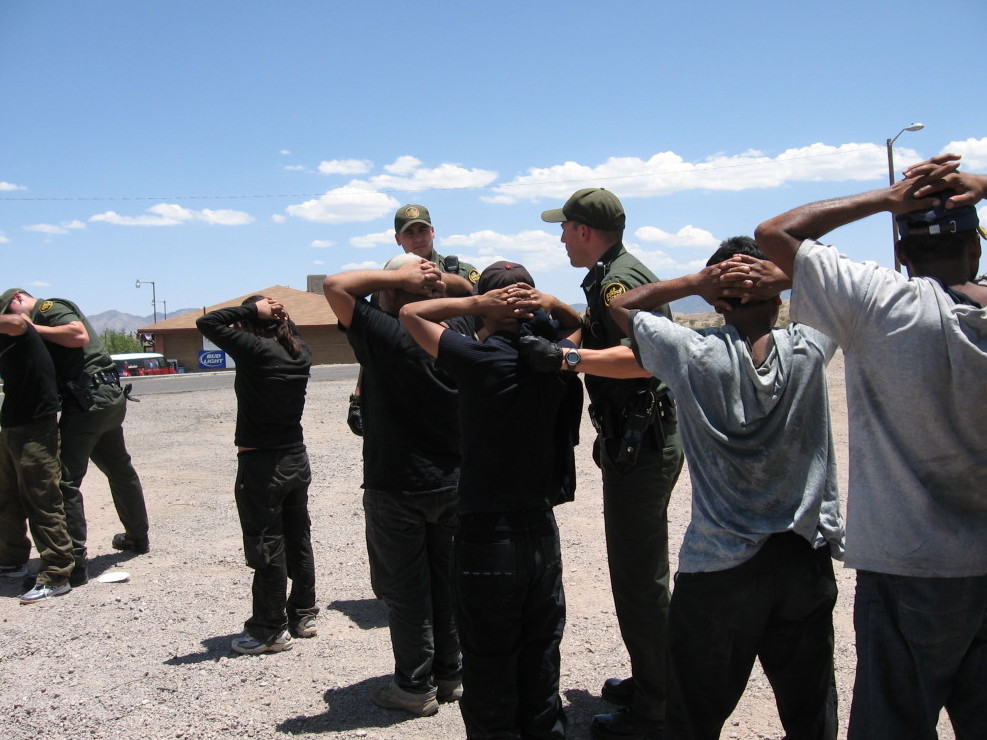 Border Patrol agents arrest migrants in 2007 after they illegally crossed into Nogales, Ariz. Operation Streamline puts such people into federal courts, giving them criminal records. The Border Patrol says the program allows the agency to focus on more serious crime, but federal judges say it causes backups in the system.