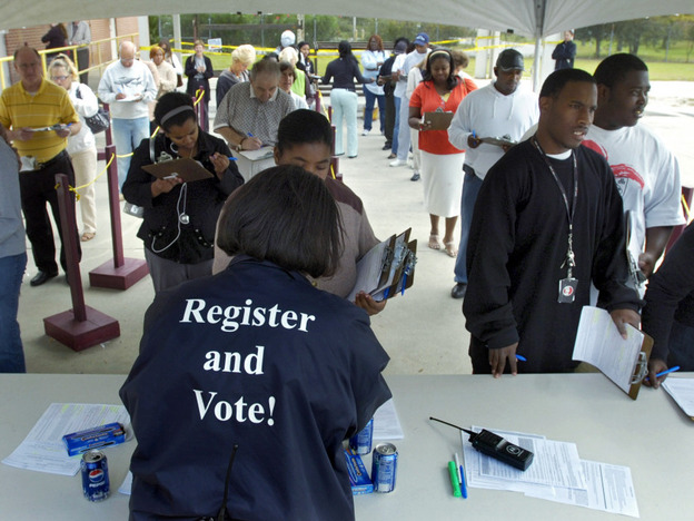 Board of Elections Customer Service Supervisor Sabrina German hands out absentee ballots in 2008.