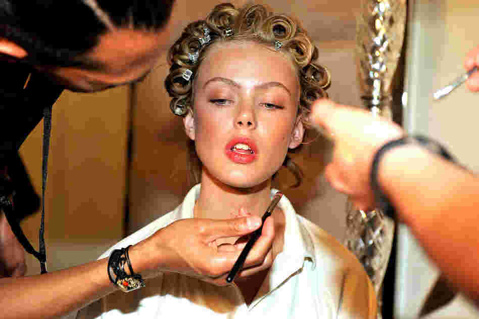 Makeup stylists work on a model moments before the Philosophy di Alberta Ferretti show Saturday. 