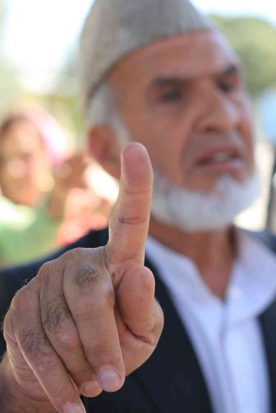 Haji Gul Nazim shows how he was able to wash off voter registration ink from his finger. Haji Gul Nazim shows how he was able to wash off voter registration ink from his finger.