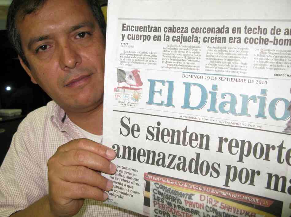 El Diario editor Pedro Torres with the front page featuring the Mexican flag dripping blood. El Diario editor Pedro Torres with the front page featuring the Mexican flag dripping blood.