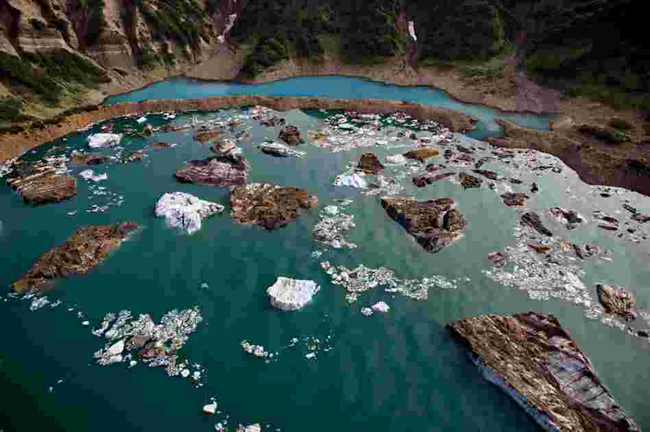 Bergs and boulders form islands of ice and rock in the basin of Red Glacier, Alaska.