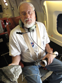 Bob Pasken from Saint Louis University prepares to release a dropsonde into Hurricane Karl while flying above it. The devices relay crucial data about winds, temperature, humidity and pressure back to researchers.
