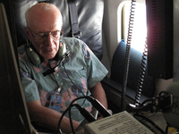 Ed Zipser from the University of Utah adjusts the flight plan aboard the NASA DC-8 studying Hurricane Karl. Zipser and other scientists flew patterns over the storm to gather data to learn why some storms gain strength while others weaken.