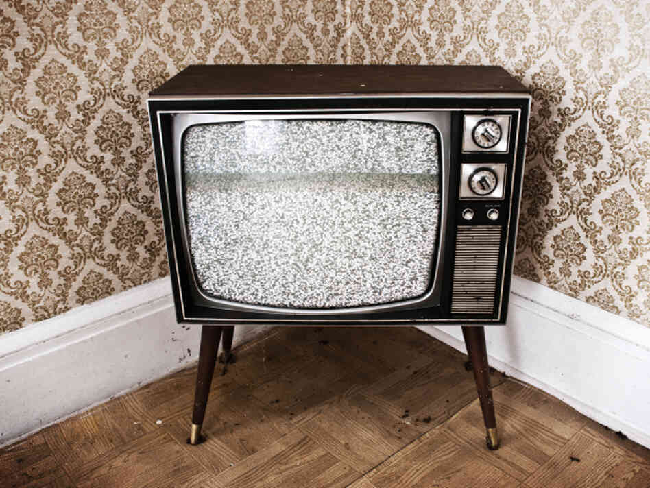 a television in a corner, with static on the screen a television in a corner, with static on the screen
