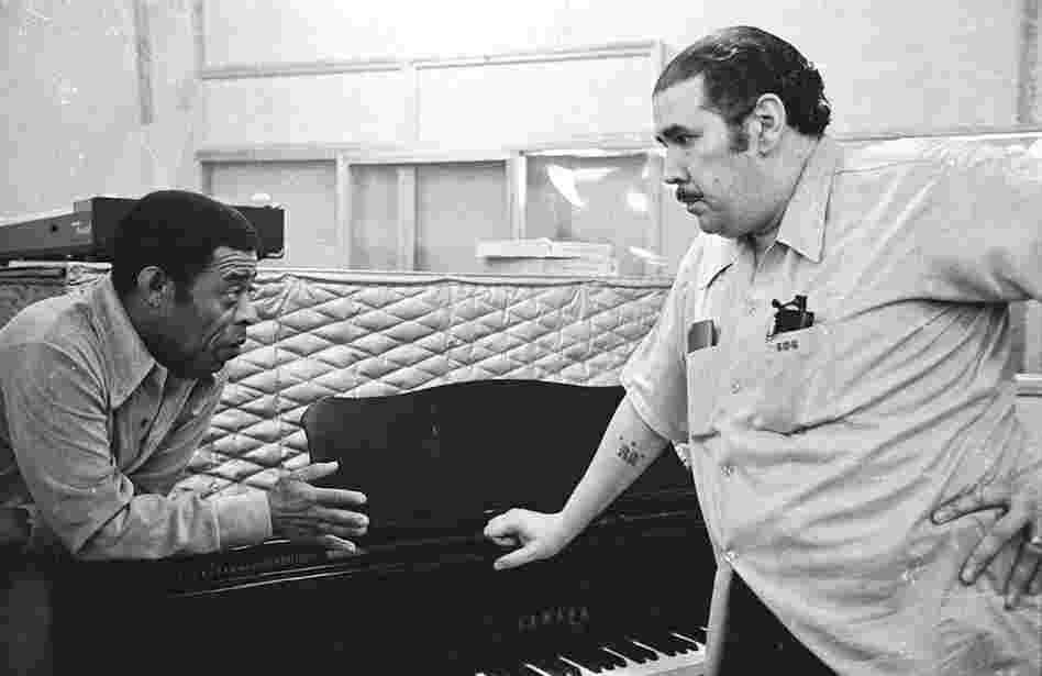 Bongocero Jose Mangual Sr. and bassist Bobby Rodriguez chat during a break in the recording of Mangual's album "Buyu" in New York City, 1977. Both musicians were veterans of many bands including probably the most important band of them all, Machito and His Afro-Cubans.