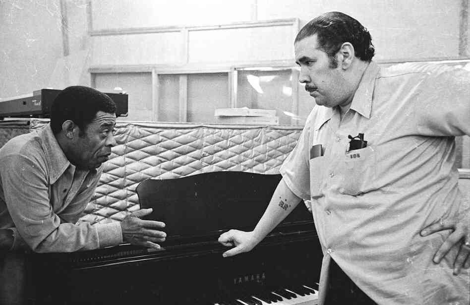 Bongocero Jose Mangual Sr. and bassist Bobby Rodriguez chat during a break in the recording of Mangual's album "Buyu" in New York City, 1977. Both musicians were veterans of many bands including probably the most important band of them all, Machito and His Afro-Cubans.