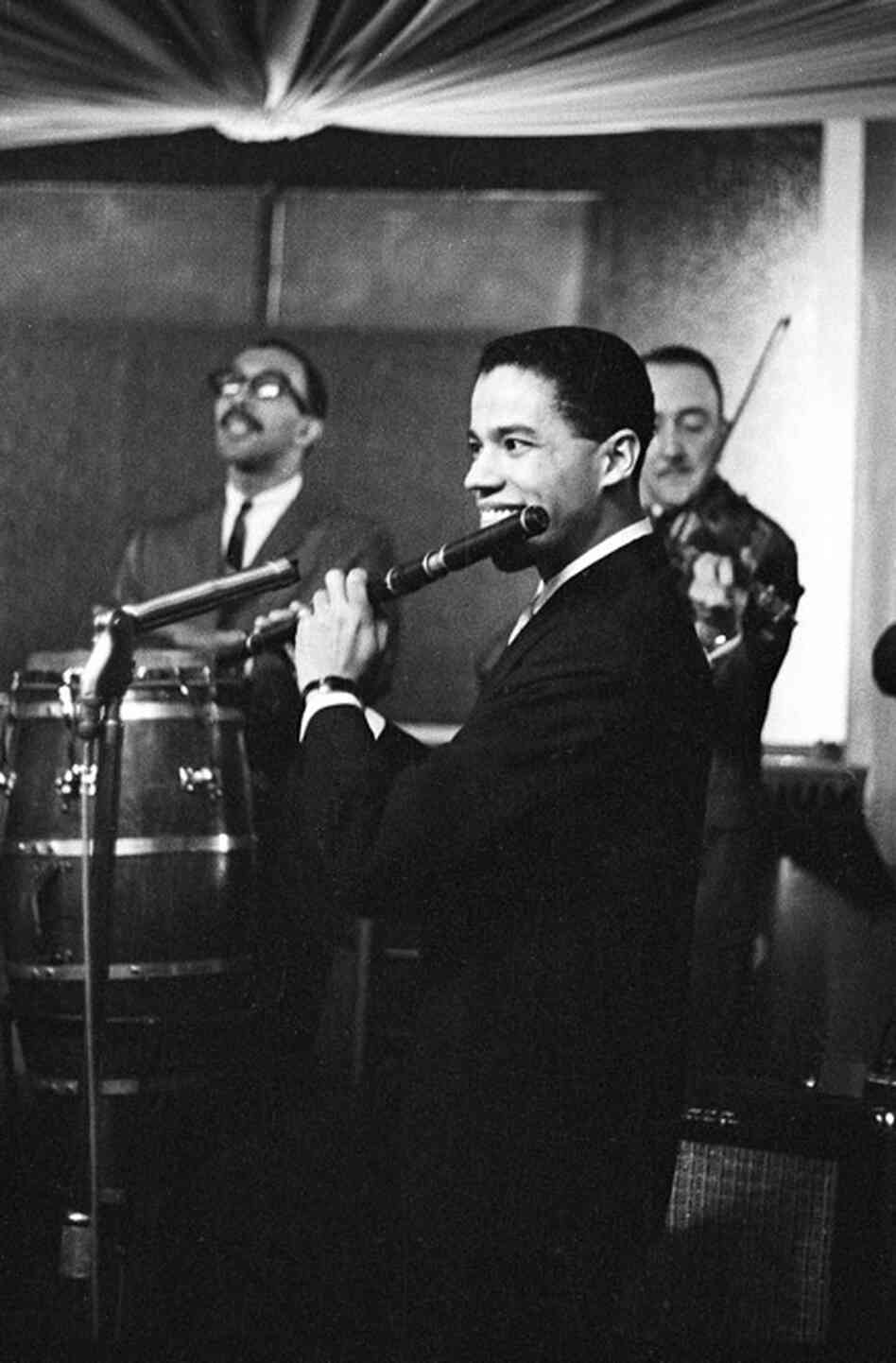 This is an early shot of musician and arranger Johnny Pacheco leading his band at the Palladium Ballroom in New York City in 1962. Pacheco would later go on to become a pivotal figure in the creation of Fania Records, the seminal salsa label.