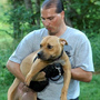 During a raid on a Missouri dogfighting ring, Tim Rickey of the ASPCA holds Dharma, a pit bull. During a raid on a Missouri dogfighting ring, Tim Rickey of the ASPCA holds Dharma, a pit bull.