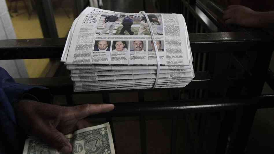 A vendor sells a copy of Los Angeles Times with an article on Bell city officials on Wednesday. A vendor sells a copy of Los Angeles Times with an article on Bell city officials on Wednesday.