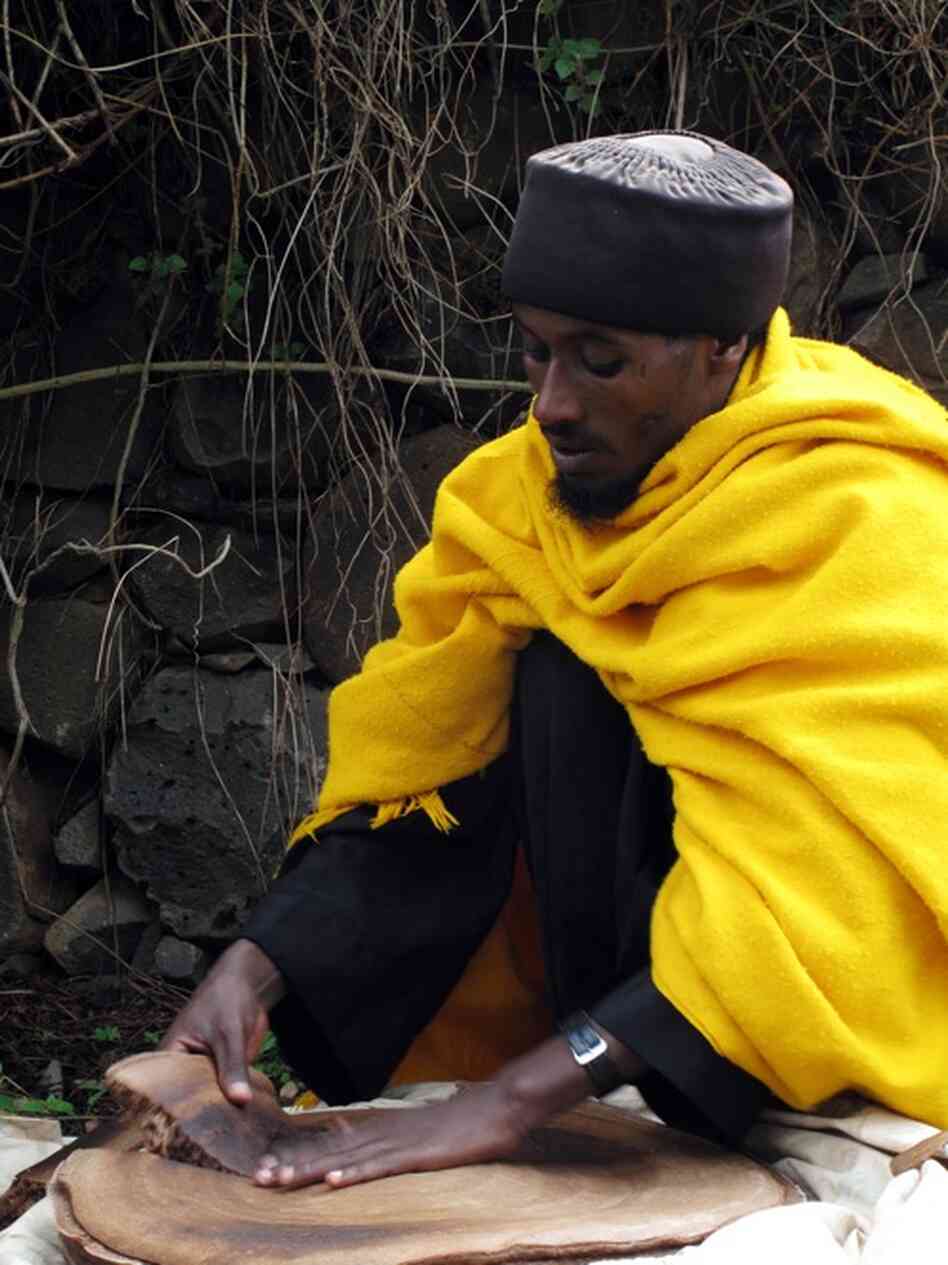A priest is the only person allowed to prepare the bread that feeds the faithful at an ancient monastery on an island in Lake Tana, in the Ethiopian highlands. He distributes the bread after morning services.