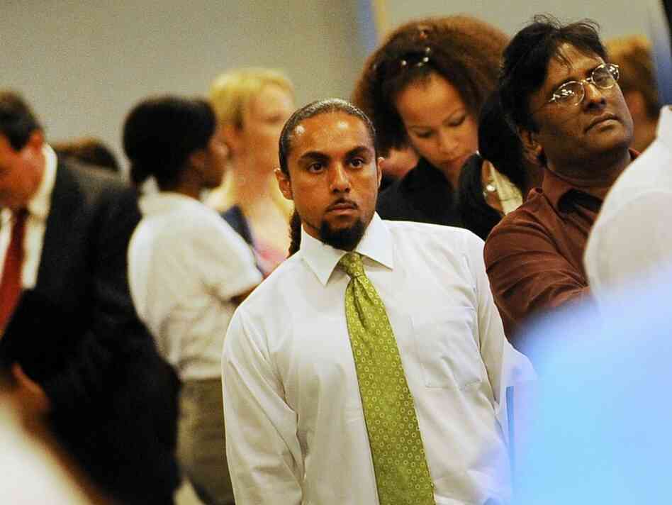 Job seekers wait in line to talk with re Job seekers wait in line to talk with re