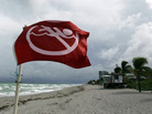 A warning flag on the empty beach in Dania Beach, Fla. Tuesday, Sept. 28, 2010. A warning flag on the empty beach in Dania Beach, Fla. Tuesday, Sept. 28, 2010.