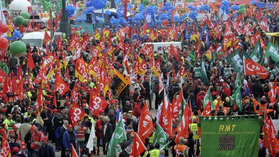 Thousands of demonstrators march down a boulevard in Brussels to protest government austerity plans. Thousands of demonstrators march down a boulevard in Brussels to protest government austerity plans.