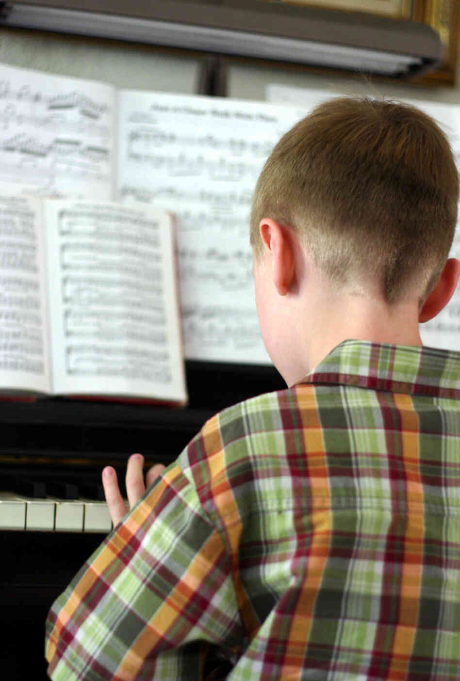 A boy plays piano A boy plays piano
