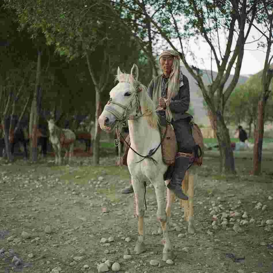 A Kyrgyz horseman prepares to check on his herd of sheep and goats outside the village of Ghaz Khan. The Pamir Kyrgyz live at high elevations on the Pamir Mountains and leave only during the spring and summer months.