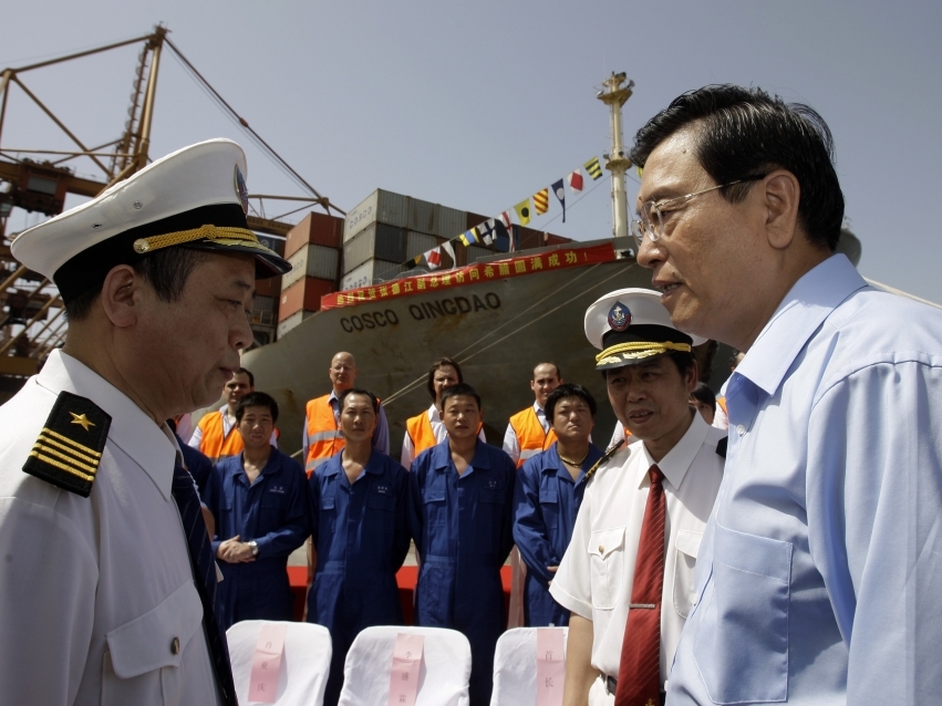 Chinese Vice-Premier Zhang Dejiang (right) talks to Cosco employees at the port of Piraeus near Athens in June. The Chinese company runs a major container port in Piraeus, but the prospect of more Chinese investment in the country is splitting Greeks.
