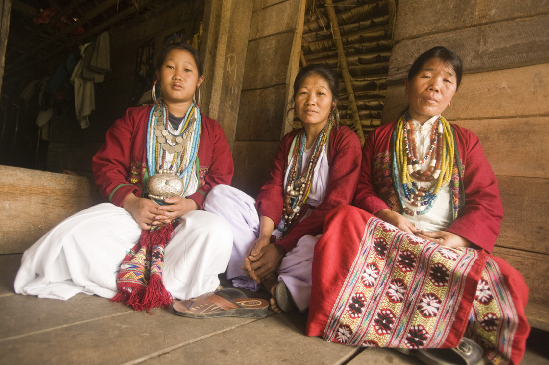 Three speakers of the newly identified language Koro  gather at a house in Kichang village in India.