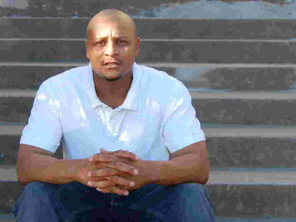 Mark Richardson sits on the steps of a courthouse in Texas. Mark Richardson sits on the steps of a courthouse in Texas.