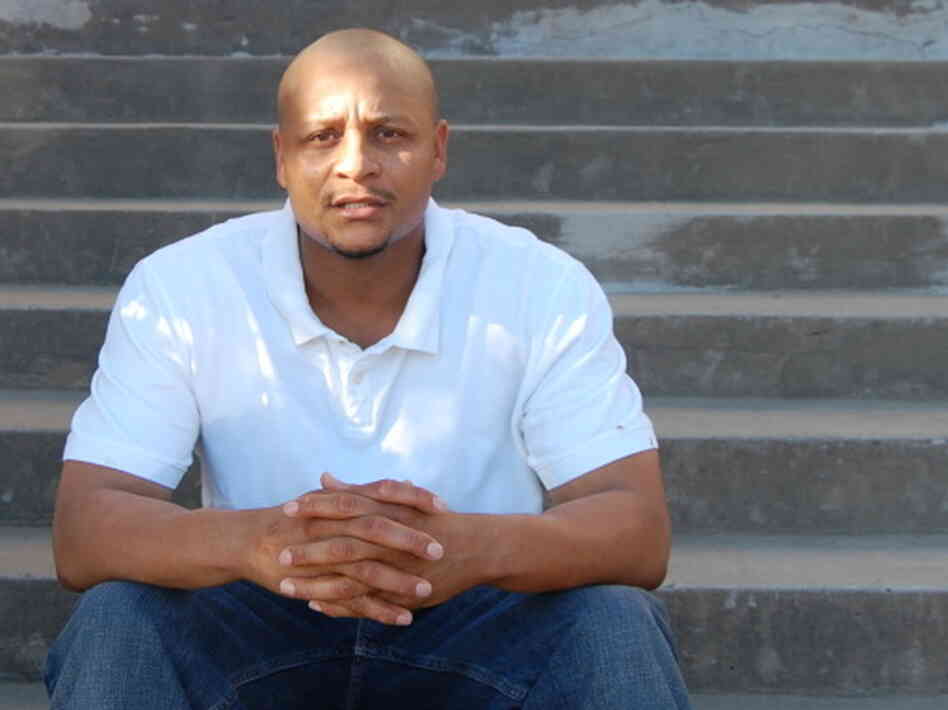Mark Richardson sits on the steps of a courthouse in Texas. Mark Richardson sits on the steps of a courthouse in Texas.