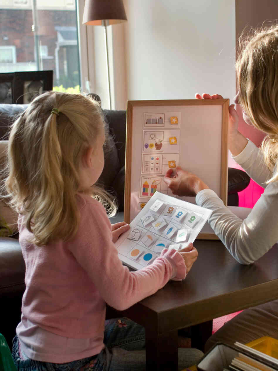 A teacher and a girl with autism. A teacher and a girl with autism.