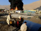 Local residents collect oil from the burning oil depot after gunmen attacked NATO tankers in Quetta Local residents collect oil from the burning oil depot after gunmen attacked NATO tankers in Quetta