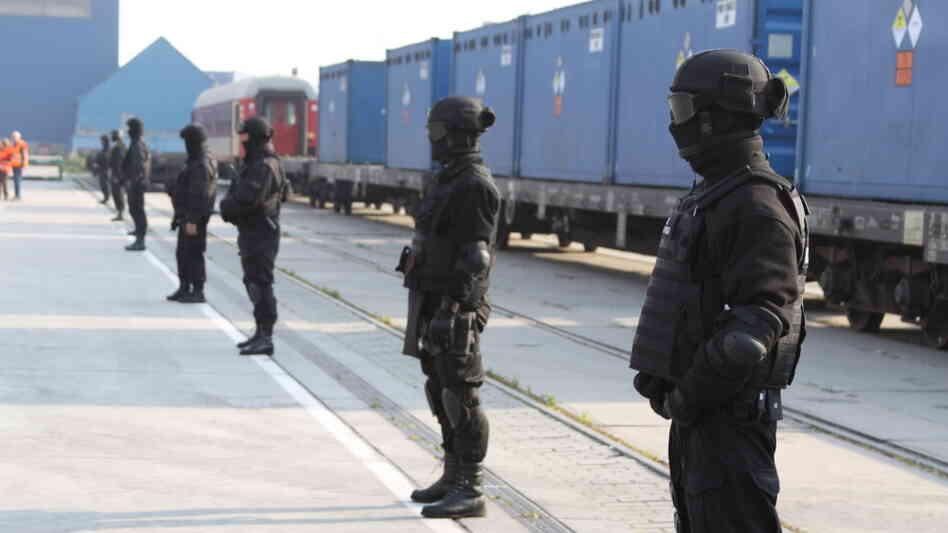 Guards stand in front of containers of highly enriched uranium in the port at Gdynia Guards stand in front of containers of highly enriched uranium in the port at Gdynia