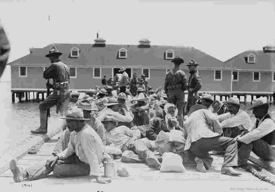 Mexican refugees on a dock under guard of U.S. soldiers, 1913.  At least 400 Mexicans entered the United States via Angel Island during the Mexican Revolution. 