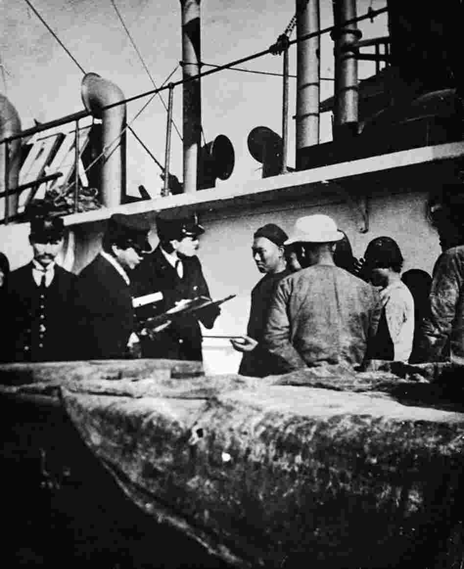 Immigration inspectors and an interpreter question Chinese immigrants arriving by ship in Portland, Ore., circa 1904-1910. Because the Chinese Exclusion Act of 1882 prohibited Chinese laborers from entering the United States, Chinese migrants were detained until their immigration status could be verified. 