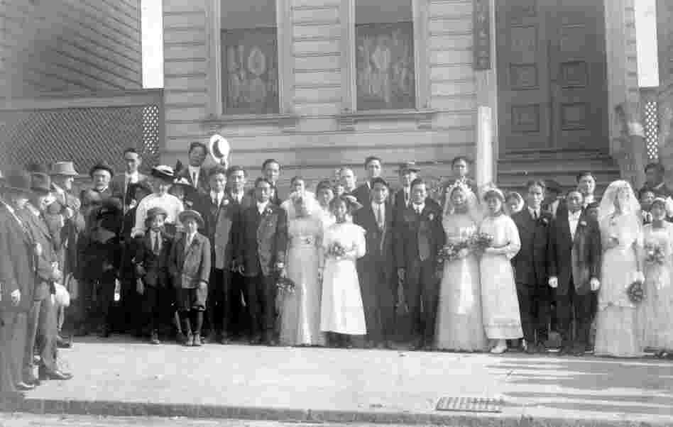 Newly married Korean couples pose in front of the Korean Methodist Church on San Francisco's Bush Street (date unknown). Many of the Korean immigrants passing through Angel Island were "picture brides," matched with Korean laborers working in the U.S. by matchmakers. Until 1917, picture brides were required to be remarried under U.S. law before being admitted to the country. (Courtesy of USC Ko...
