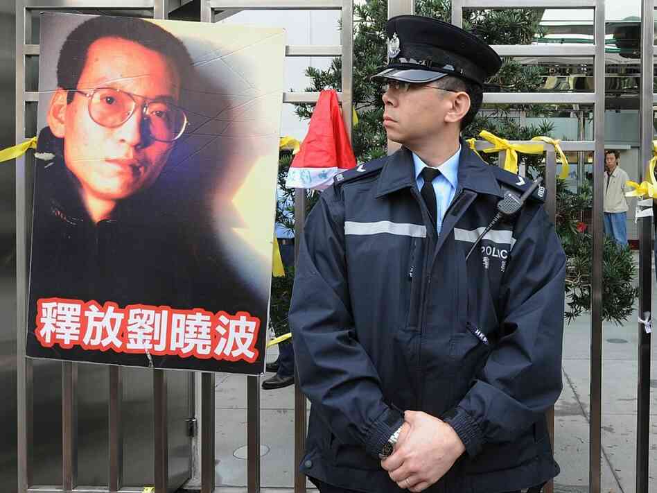From December 25, 2009: A Hong Kong policeman stands next to a post of jailed Chinese dissident (now From December 25, 2009: A Hong Kong policeman stands next to a post of jailed Chinese dissident (now