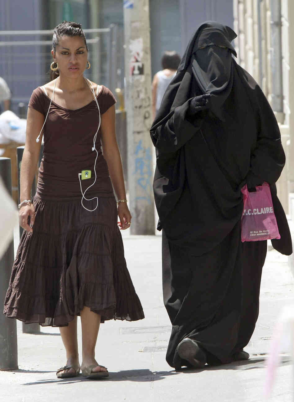 Two women, one wearing a niqab, walk in Marseille, France. Claude Paris/AP Two women, one wearing a niqab, walk in Marseille, France. Claude Paris/AP