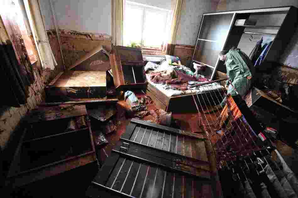 A resident inspects his belongings on Oct. 6 after a wave of toxic red mud swept through his village. 