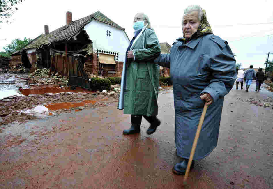 Residents return to check their homes in Kolontar on Oct. 6 , two days after a wave of toxic red mud swept through the small village. 