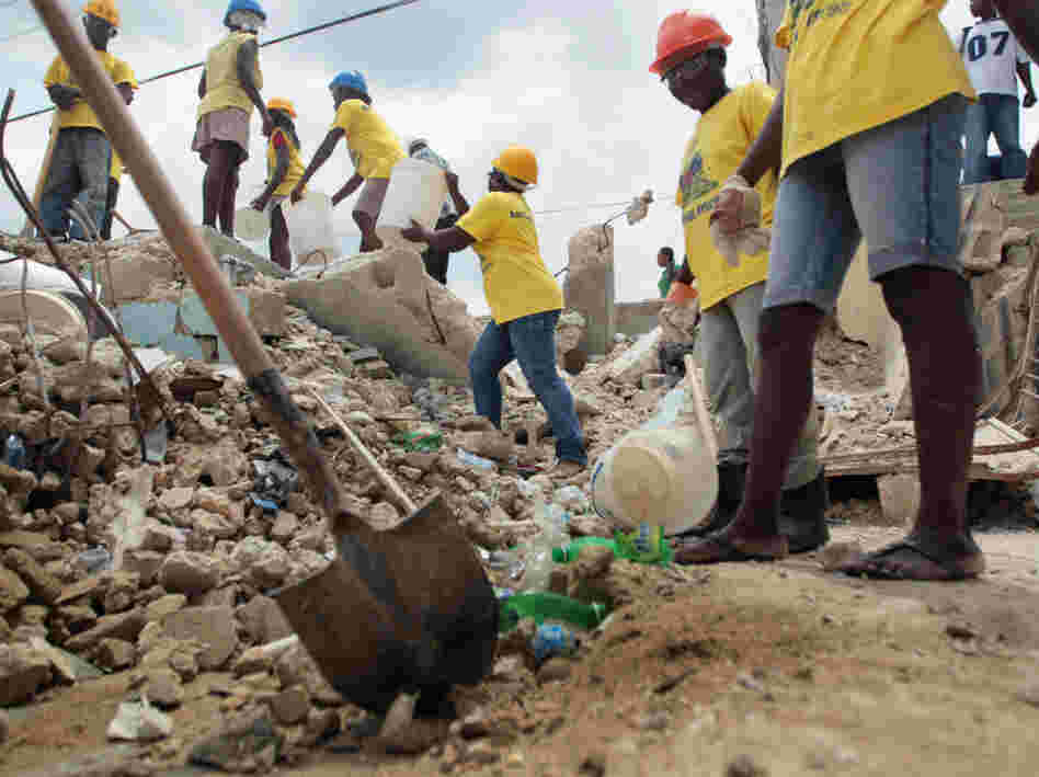 Workers clear rubble from a collapsed building in Port-au-Prince Workers clear rubble from a collapsed building in Port-au-Prince