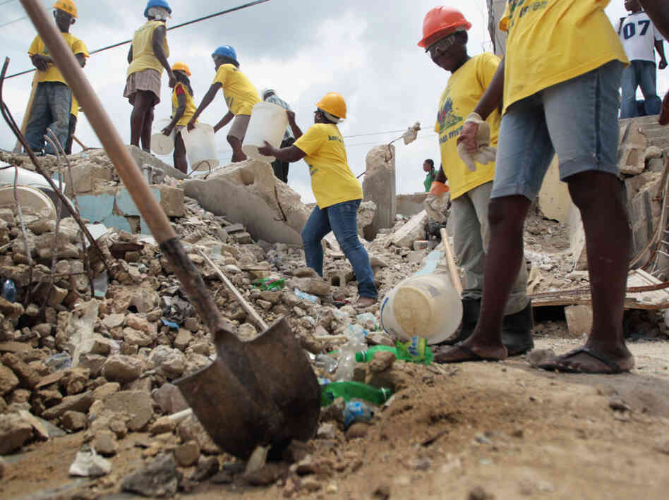 Workers clear rubble from a collapsed building in Port-au-Prince Workers clear rubble from a collapsed building in Port-au-Prince