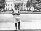 Condoleezza Rice stands in front of the White House as a girl.