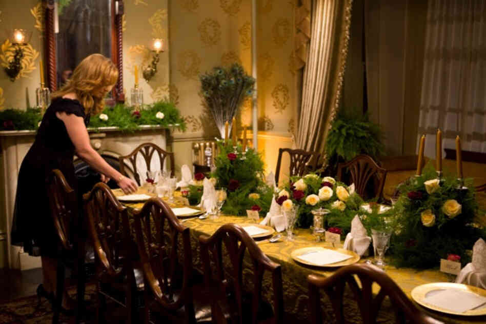 Chris Kimball's wife, Adrienne, prepares the back parlor of their 1859 Victorian home for the 12-course meal featured in Fannie Farmer's Last Supper.