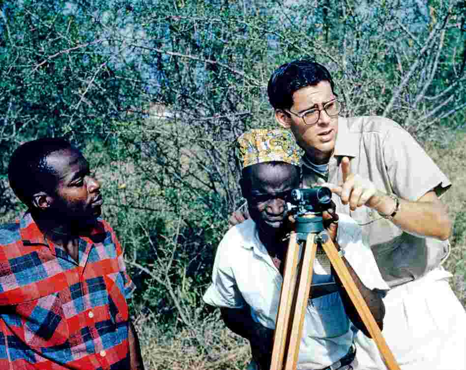 Gene Schreiber shows local municipalities how to survey for road construction, 1962