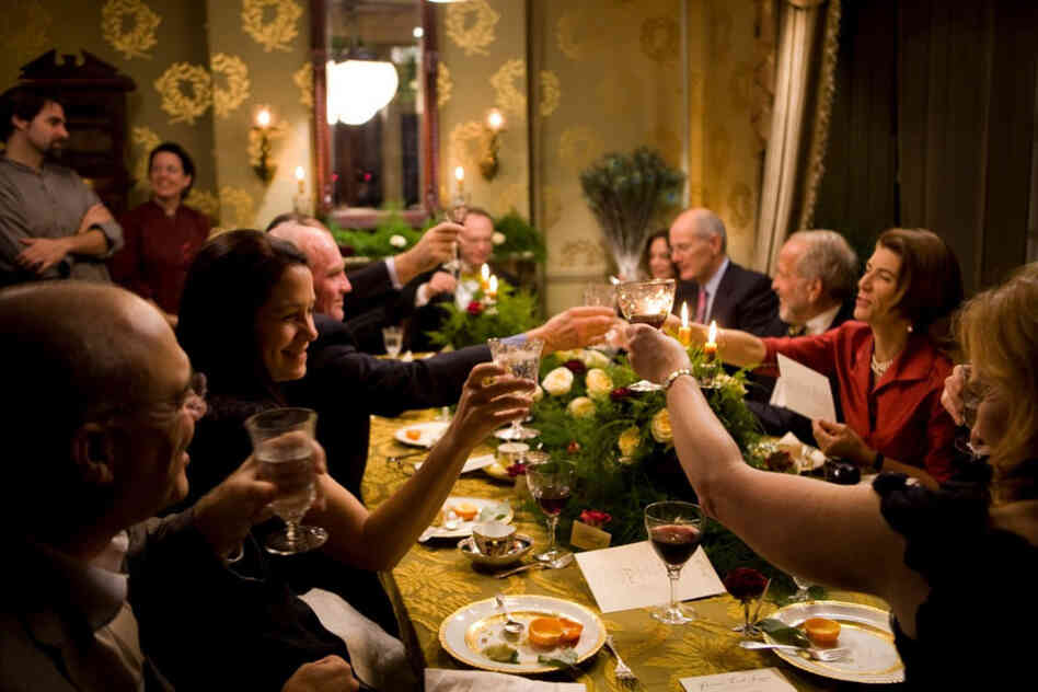 Guests, including Chicago Tribune columnist Amy Dickinson (right) and Mark Bittman (left) of The New York Times, give an after-dinner toast to the cooks.