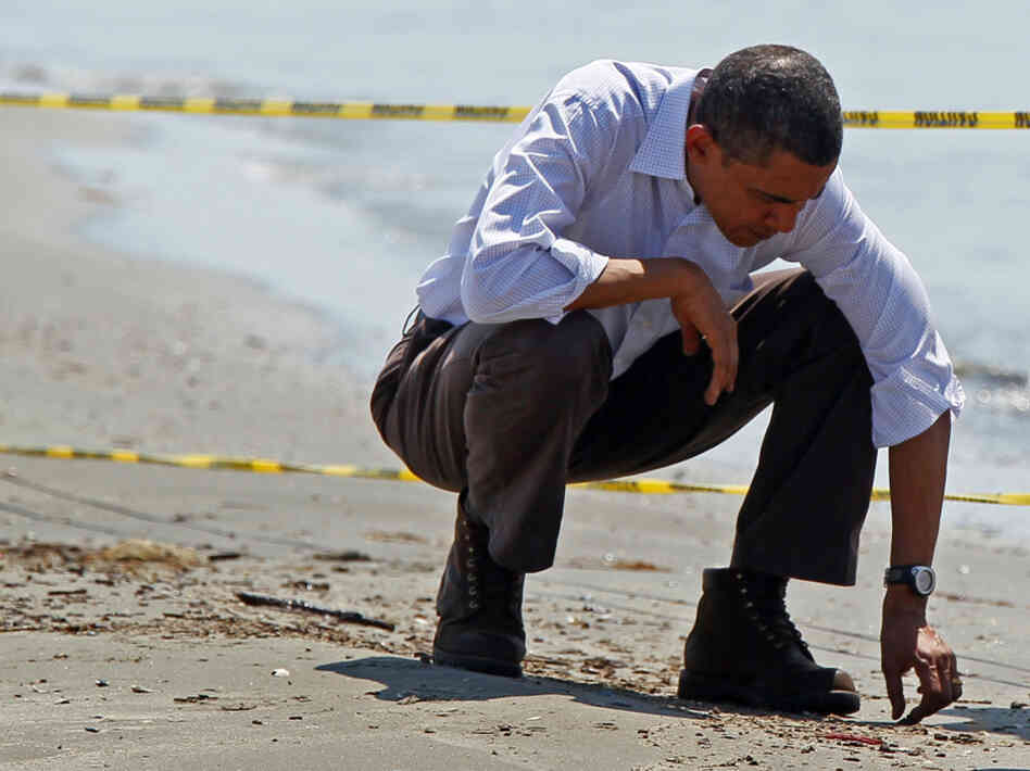 President Obama picks up balls of tar while touring the beach in Port Fourchon, La President Obama picks up balls of tar while touring the beach in Port Fourchon, La