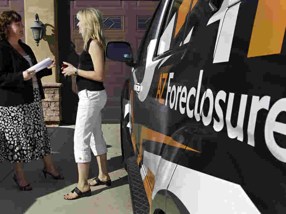 A Realtor and real estate investor outside a foreclosed property