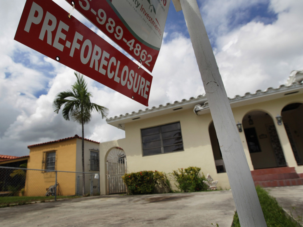 A pre-foreclosure sign hangs in front of a home in Miami, Florida.