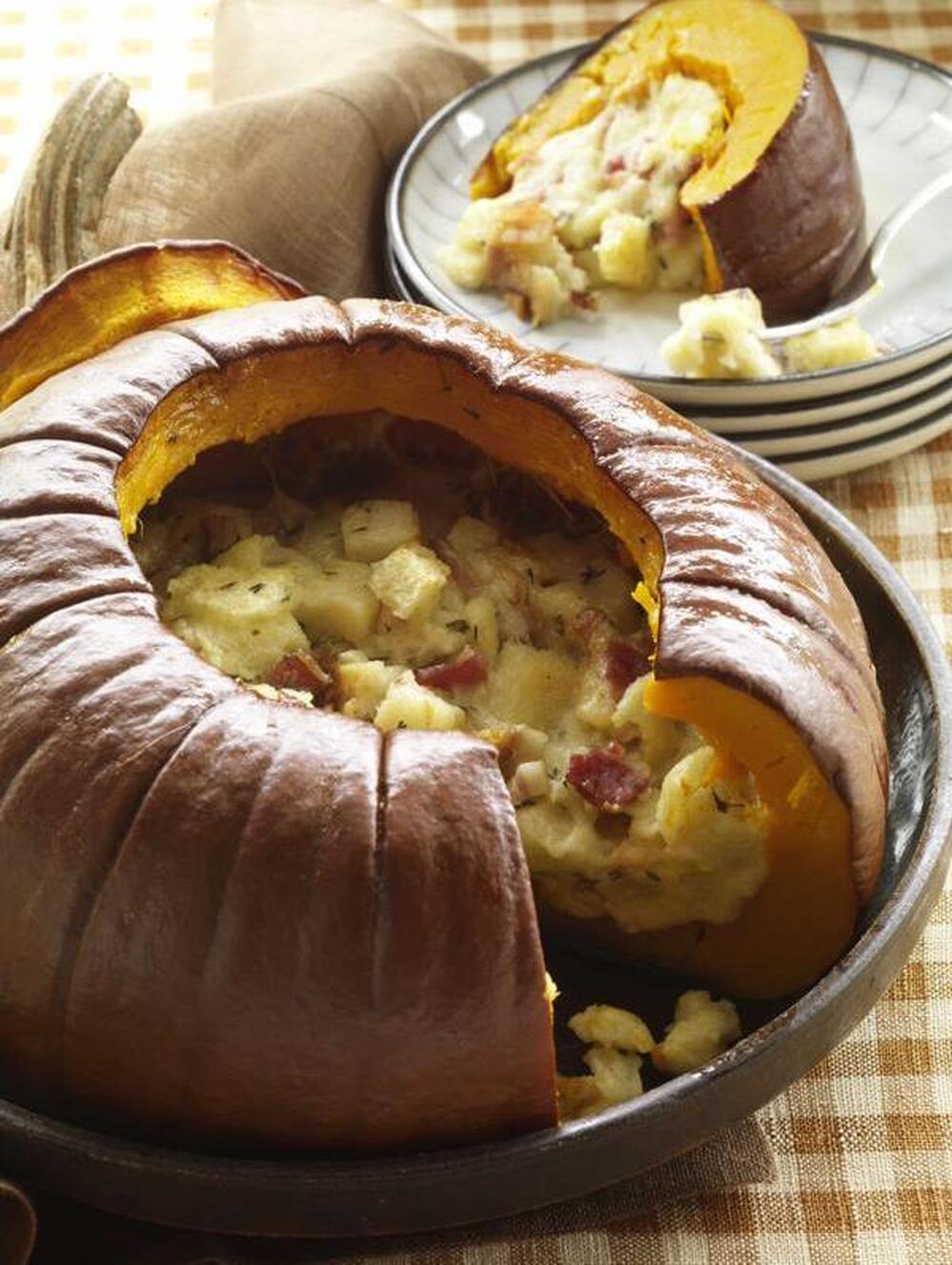 A pumpkin stuffed with bread, bacon, garlic, and cheese can be a main course. 