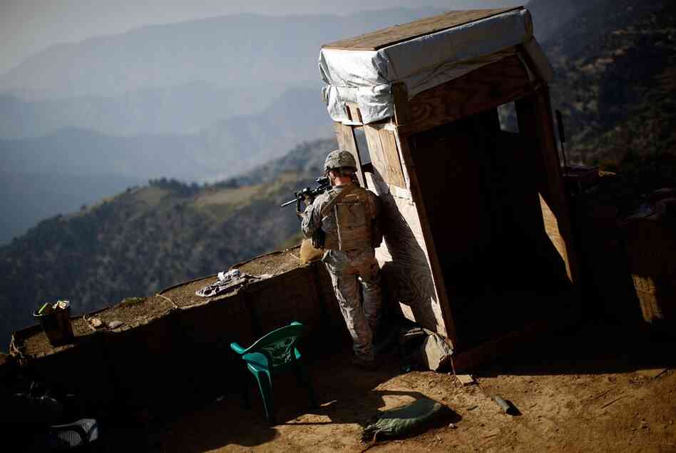 A U.S. soldier keeps watch at a recently abandoned American base on the Afghanistan-Pakistan border. The soldiers refer to these compounds as belonging to the "OGA," or "Other Government Agency," common slang for the CIA.