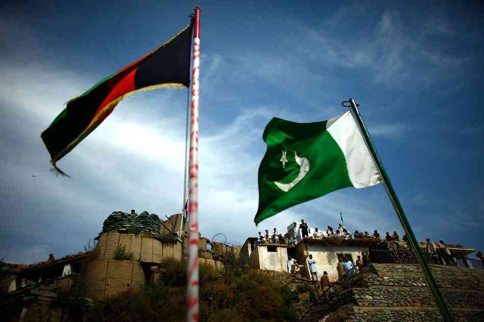 Flags fly at the Afghanistan-Pakistan border. On the rooftops, the Lashgar are members of the local Pakistani population who support the government — an informal posse fighting against the Taliban, as Salim says.