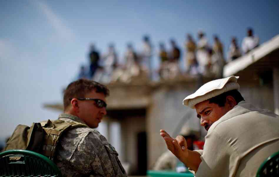 Billig shares a cup of tea and conversation with Pakistani Army Lt. Col. Ahmed Salim at a border crossing at Ghakhi Pass. Salim invites the Americans across the border for lunch. On the roof are three dozen men with beards, turbans and Kalashnikov rifles. They're not Taliban, Salim insists, but pro-government militiamen.