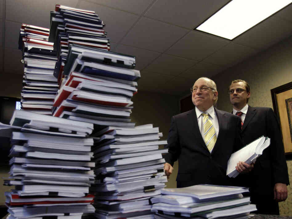 Attorneys pose with stacks of depositions from 150 robo-signers. Attorneys pose with stacks of depositions from 150 robo-signers.